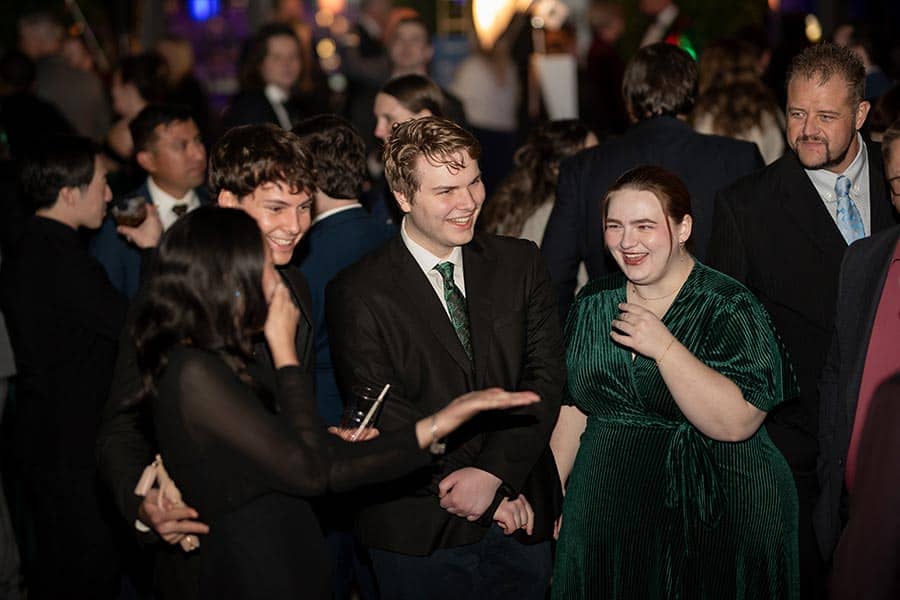 A group sharing a laugh at the 2025 party.