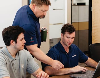 A group of Vertech employees sharing knowledge and collaborating.