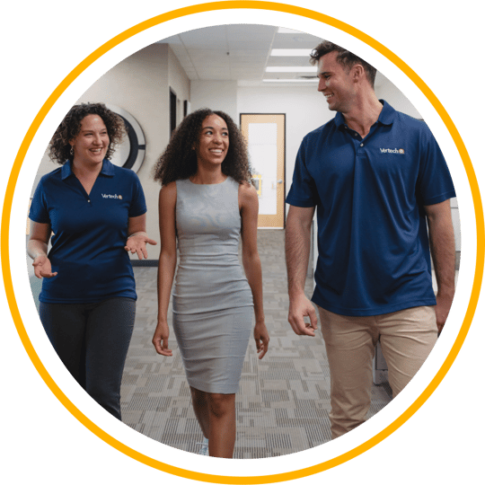 Three Vertech team members walking together and smiling.
