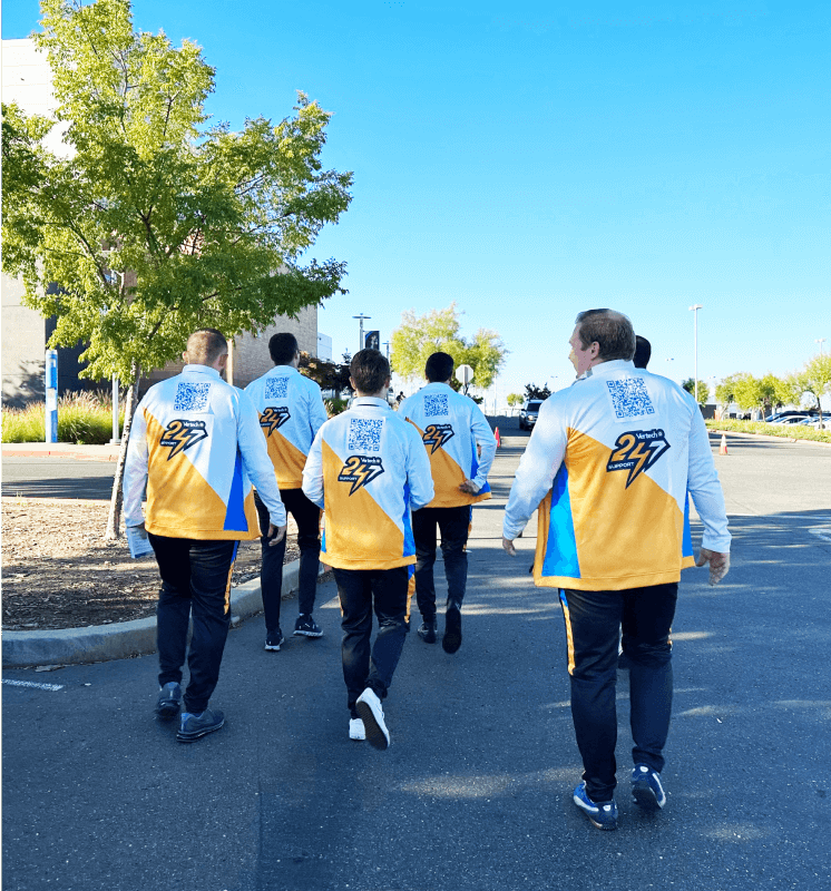 Vertech team members walking outdoors, wearing themed Esports outfits.