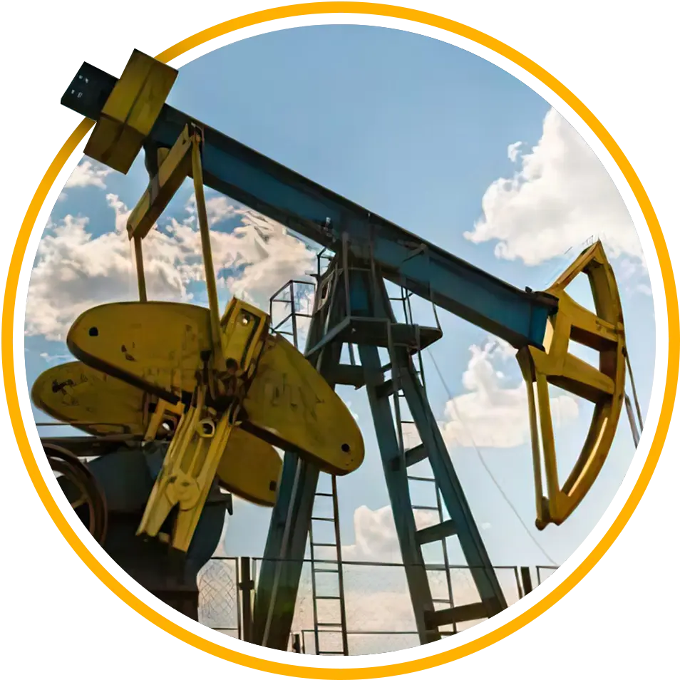 Oil well field pumpjack beneath blue cloudy sky