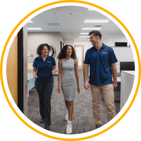Three Vertech team members walking together and smiling. 