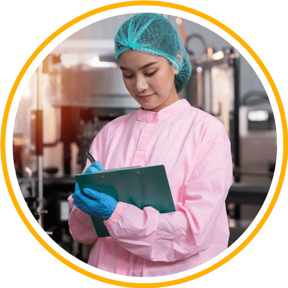 A woman wearing a hairnet and gloves checks off items on a clipboard.
