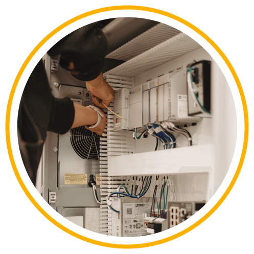 Person working on panel fabrication services managing wires.
