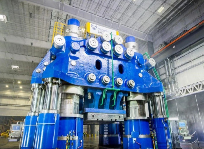 A large industrial hydraulic press at Weber Metals.
