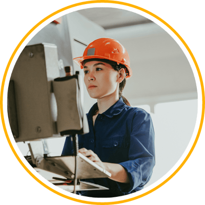 Woman in Manufacturing looking at machine hmi